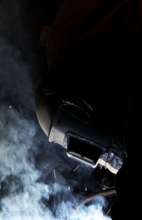 a welder working at shipyard at night