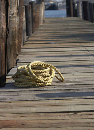 a yellow rope on old wood pierの写真素材