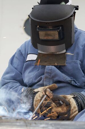 a welder working at shipyard during dayの写真素材