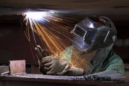 a welder working at shipyard during night shift