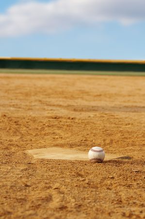 one baseball on home plate at a sports fieldの写真素材