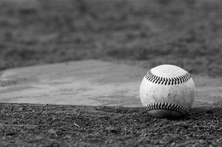 one baseball on home plate at a sports fieldの写真素材