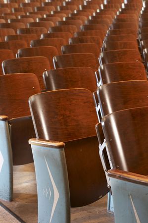 rows of wood chairs in an old auditoriumの写真素材