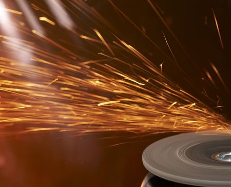 a close up picture of sparks on a grinding wheelの写真素材
