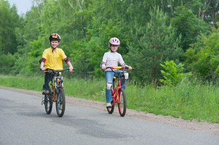 young boy and young girl on bike