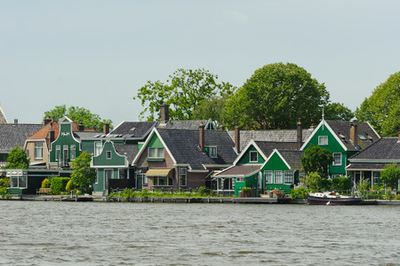 Traditional dutch houses near the canal in summer day. Netherlandsの写真素材
