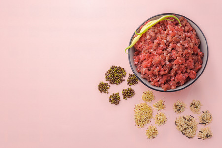 Natural raw ingredients for pet food on pink background. Flat lay.の写真素材