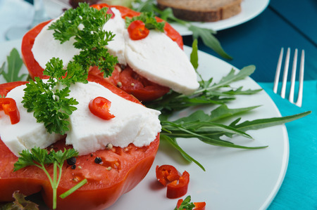 Delicious Caprese salad with mozzarella cheese, ripe tomatoes and fresh ruccola. Horizontal.の写真素材