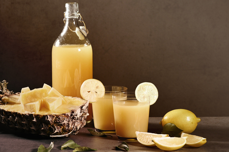 Bottle of homemade pineapple juice with ginger, lemon and ingredients. Horizontal.の写真素材