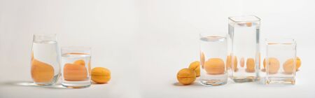 Perspective, fractured and skewed images of common foods as seen through vessels filled with water.の写真素材
