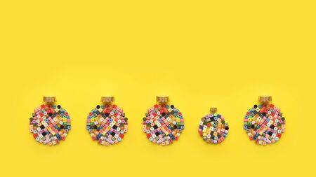 Christmas Bauble made of decoration elements on yellow background. Flat lay. Contemporary design. Contemporary art. Creative conceptual and colorful collage.の写真素材