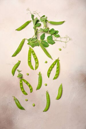 Green peas lie on a light gray background.の写真素材