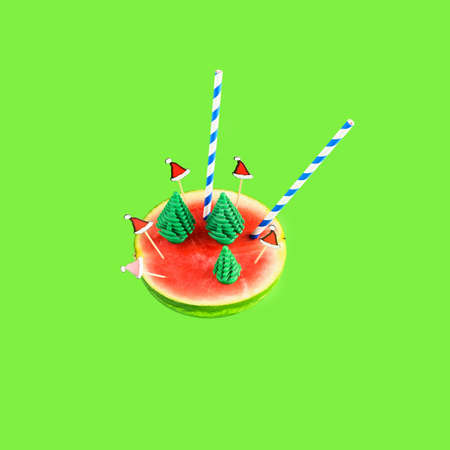 Cut watermelon with tubes and Christmas decor as a cocktail on a bright backgroundの写真素材
