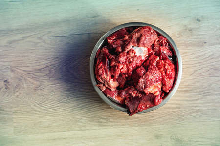 Fresh raw meat in a bowl is healthy food for a dog. View from above.の写真素材