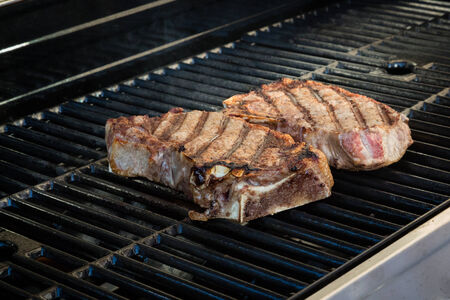 Cooking steaks on the grill の写真素材