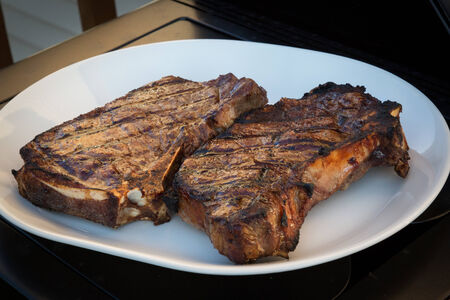 Cooking steaks on the grill の写真素材
