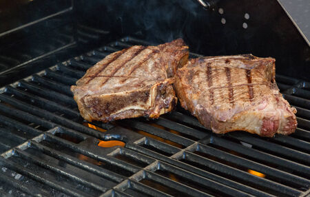 Cooking steaks on the grill の写真素材
