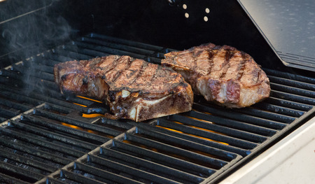 Cooking steaks on the grill の写真素材