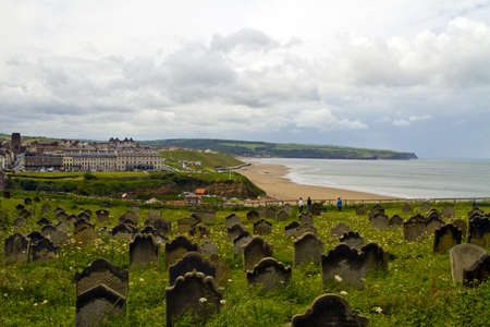 A veiw across the graveyark at the church of st mary to whitby bay