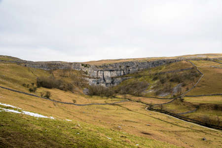 View of Malham cove in north yorkshire,from the hill side in winterの写真素材