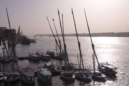 Felucca's line a pier on the Nile, Luxor, Egyptの写真素材