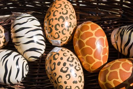Colorful wooden eggs for sale in a basket.の写真素材