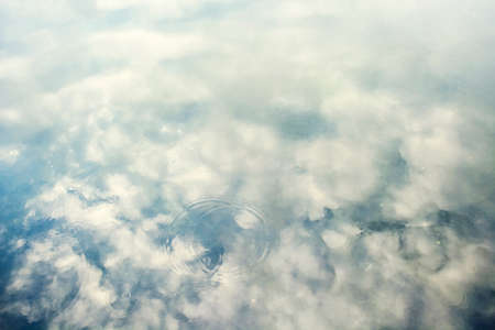 texture background in water reflects the sky with cloudsの写真素材