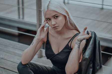 The blonde girl on the pier. in a black leather jacketの写真素材