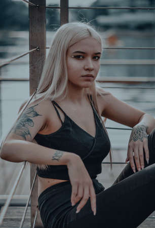 The blonde girl on the pier. in a black leather jacketの写真素材