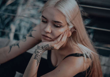 The blonde girl on the pier. in a black leather jacketの写真素材