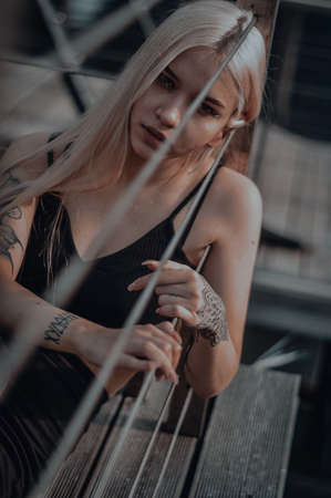 The blonde girl on the pier. in a black leather jacketの写真素材