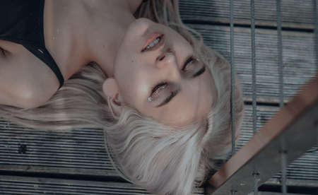 The blonde girl on the pier. in a black leather jacket