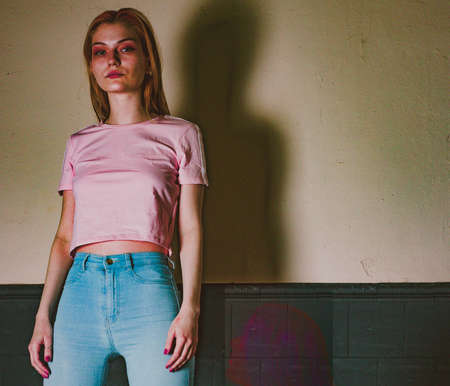 twins sisters in jeans in a photo studioの写真素材