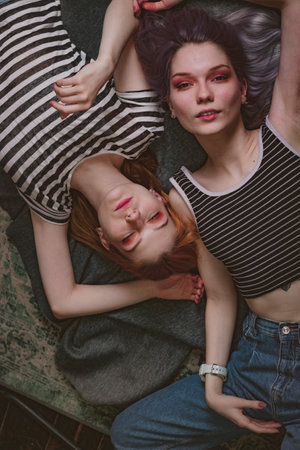 twins in striped t-shirts lie on the carpet