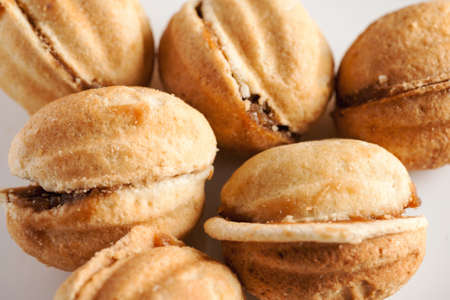 Homemade cakes in shape of nut with condensed milk, closeup shot, selective focusの写真素材
