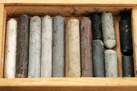 Old art crayons in wooden box close-up macro shotの写真素材