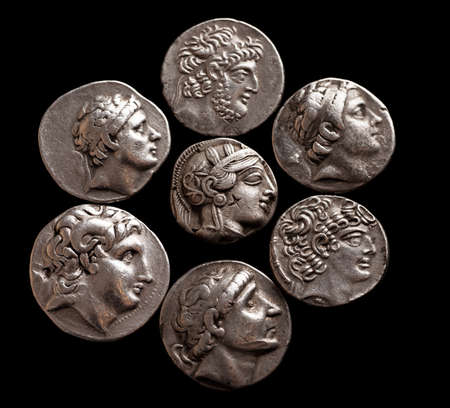 Silver coins of ancient Greece on a black background top view, selective focusの写真素材