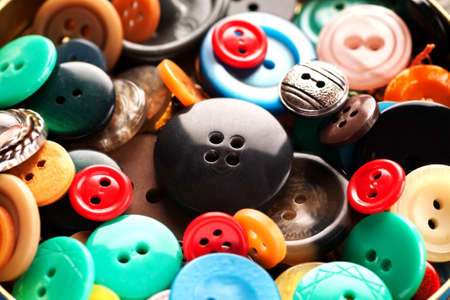 Scattering of coloured buttons close-up macro shot, selective focus