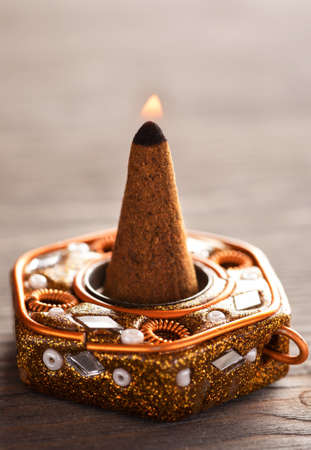 Close-up shot of aroma cone with fire in a standの写真素材