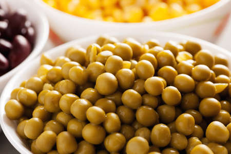 Green peas in a white bowl closeup macro shotの写真素材