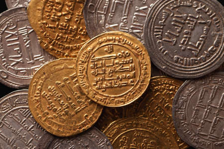 Golden and silver ancient arabic coins closeup, selective focus, top viewの写真素材