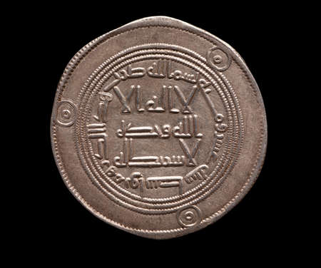 Arabic ancient silver coin isolated on black, selective focus, top viewの写真素材