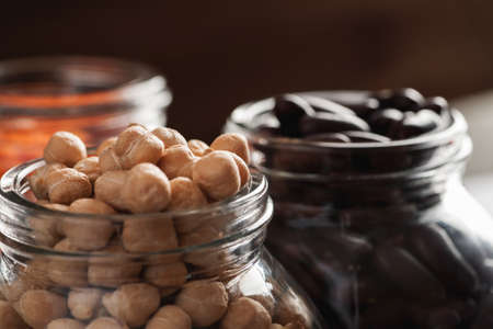 Chickpeas and red beans in glass jars macro shot, selective focusの写真素材
