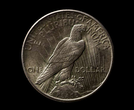 US silver 1925 year dollar with eagle isolated on black, closeup macro shot, top viewの写真素材