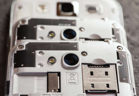 Three stacked disassembled cell phones, selective focus, closeupの写真素材