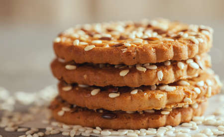 Homemade cookies with sesame on a paper napkin, front view, closeup shot, selective focus