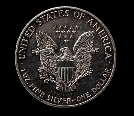 US silver dollar with eagle isolated on black, macro shot, top viewの写真素材
