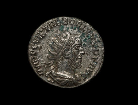 Ancient roman silver coin of Trebonianus emperor isolated on black, macro shotの写真素材