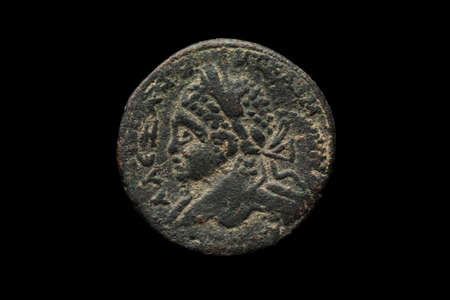 Ancient roman bronze coin isolated on black, macro shotの写真素材