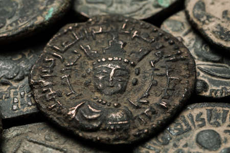 Big islamic copper coin among other coins close-up shot, selective focusの写真素材